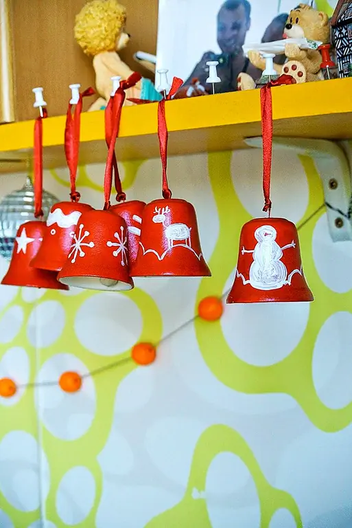 Колокольчики Jingle, представленные на Oyboystuff, сделают прекрасные украшения для елки. Самое приятное то, что вы можете создать их самостоятельно. Проект начинается с кучу керамических колоколов. Вы будете использовать акриловую краску и губчатую кисть, чтобы дать им нужный вам цвет. Нанесите слой лака для распыления в конце и используйте ленту, чтобы повесить их на дерево.