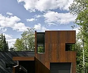 Очаровательный дом на берегу озера использует Corten Steel с смесью с природой