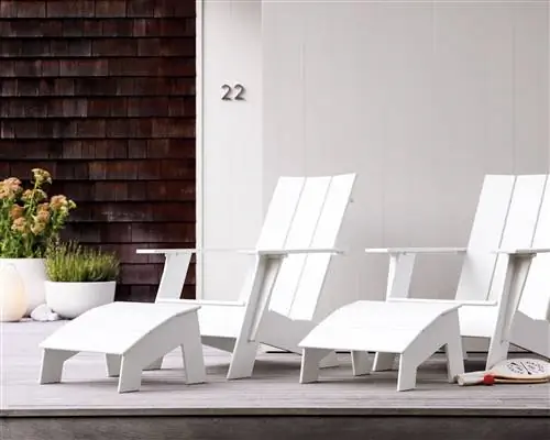 Пара белых стульев Adirondack из HDPE на современной веранде. Пара белых стульев Adirondack из HDPE на современной веранде.